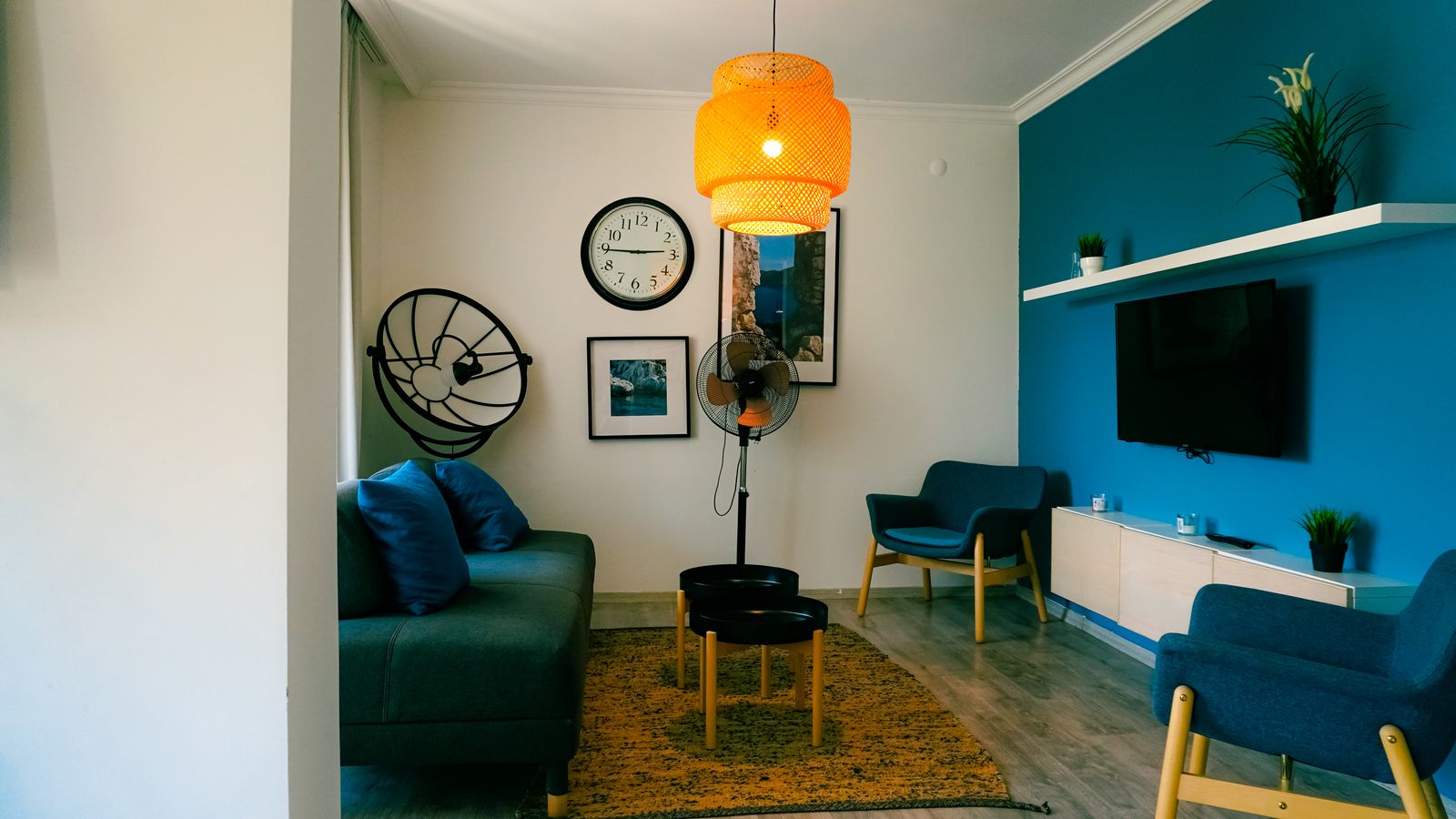 Living room inside a condominium unit with furniture and personal belongings