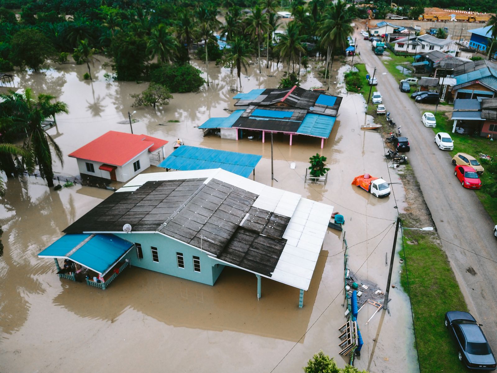 Aerial view of homes surrounded by floodwater in a residential area