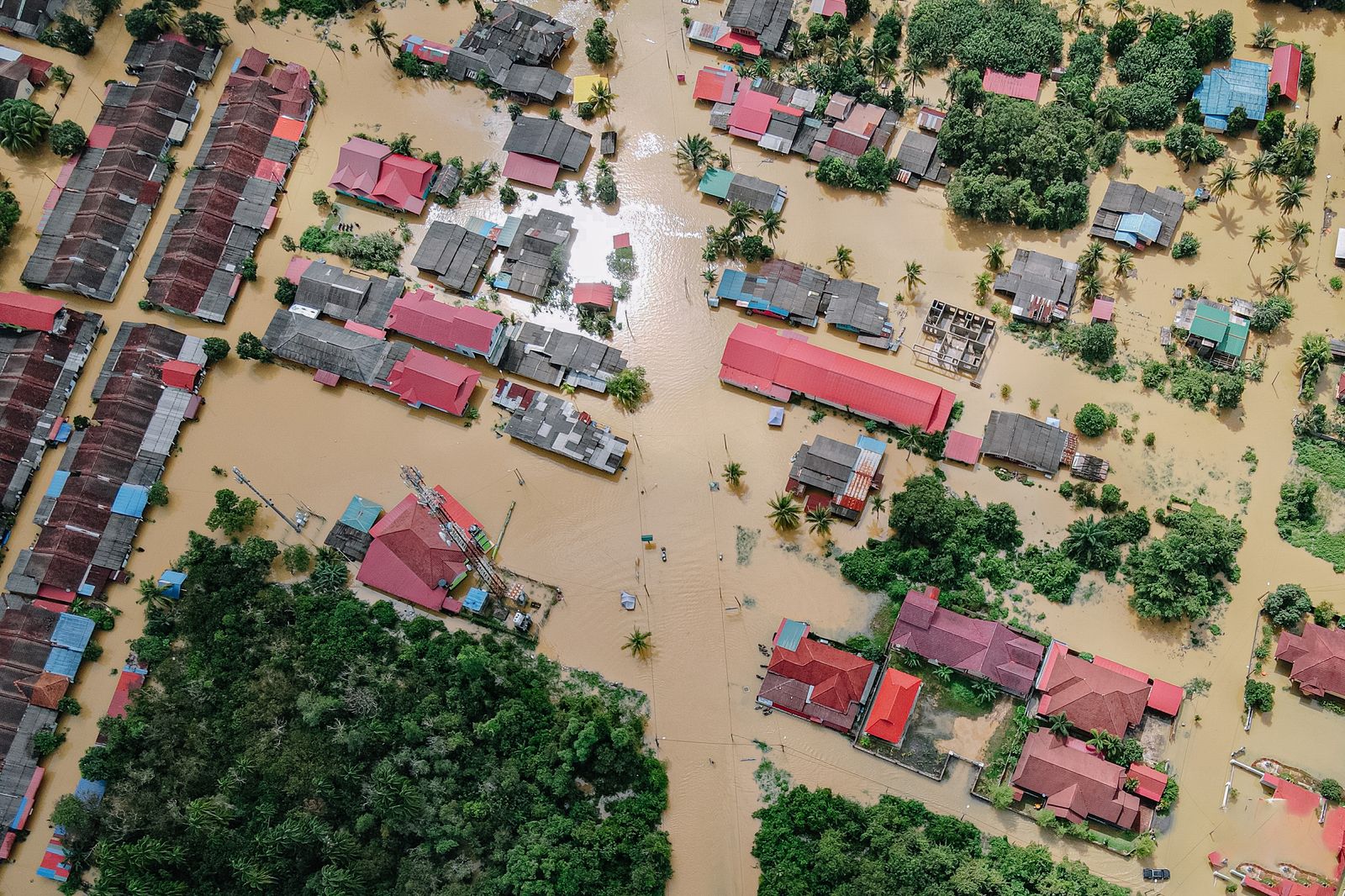 Aerial view of a residential neighborhood submerged in floodwater after torrential rains